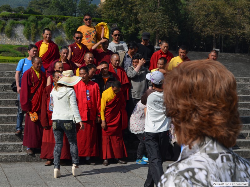 A group of visiting monks pose for pictures.