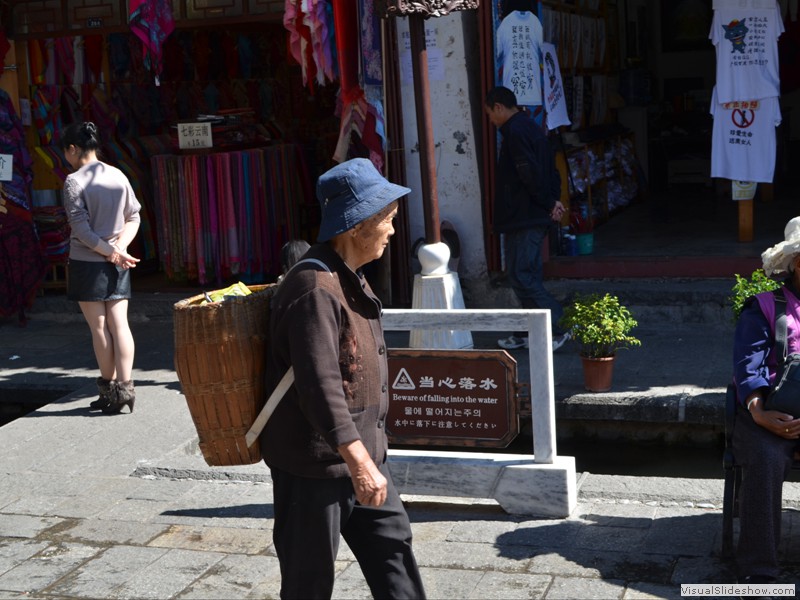 A woman carring her purchases home.