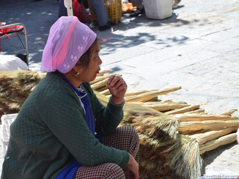 This woman was selling brooms.<br/>