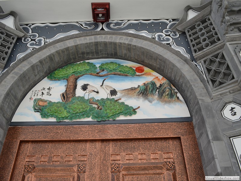A beautiful mural above an entrance door.