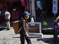 A woman carring her purchases home.