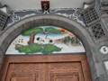 A beautiful mural above an entrance door.