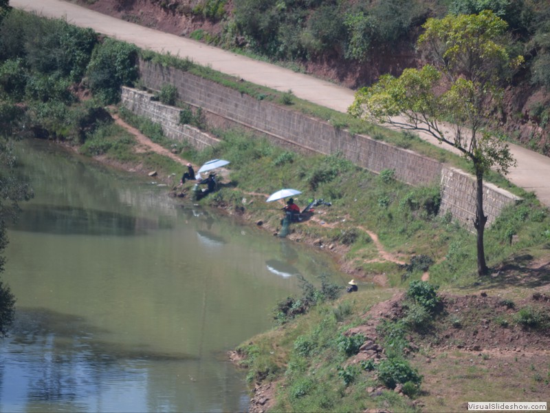 Some of the local people taking time to fish in a river.