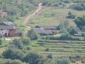 Small farms can be seen along train line.