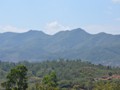 Mountains along the way on both sides of the train.