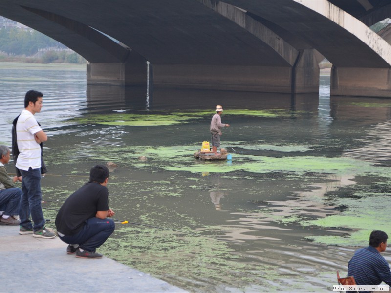 The river is shallow and the fishermen wade out to thier fishing rock platforms.