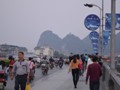 Busy traffic crossing the river bridge.