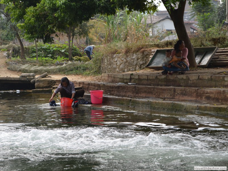 A woman washing clothes in the river.