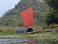 A sail boat that was docked along the river.