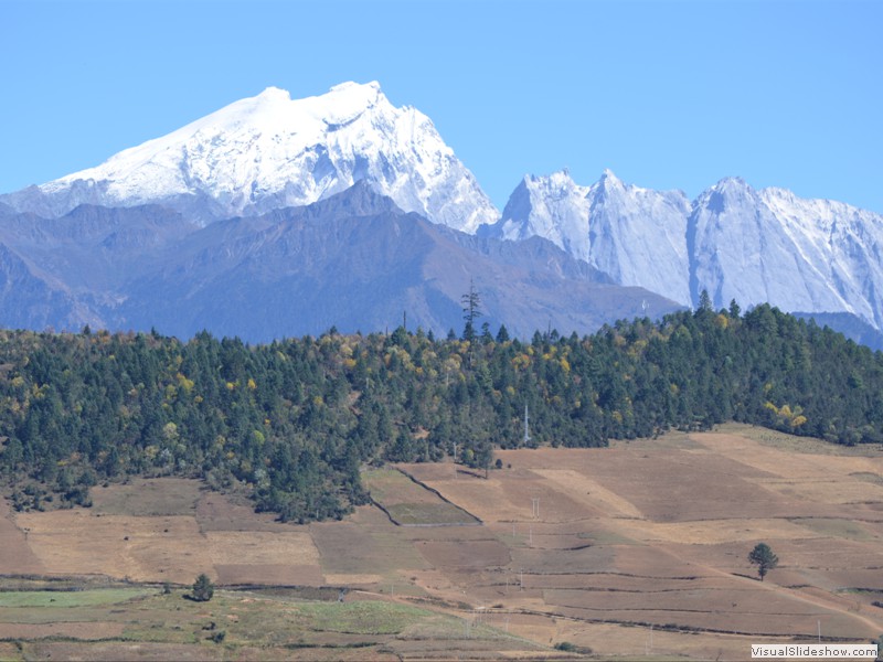 A view of the snowcapped mountains and farm field along the way.