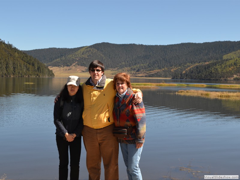 Andrea, Brad and Claudette by the lake in the park.