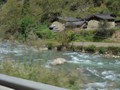 A mountain stream flows beside the road.