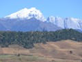 A view of the snowcapped mountains and farm field along the way.