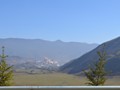 A mountain monastery visible in the distance.