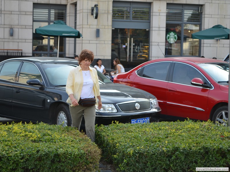 Claudette walks by one of the thousands of Buick's in China.