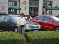 Claudette walks by one of the thousands of Buick's in China.
